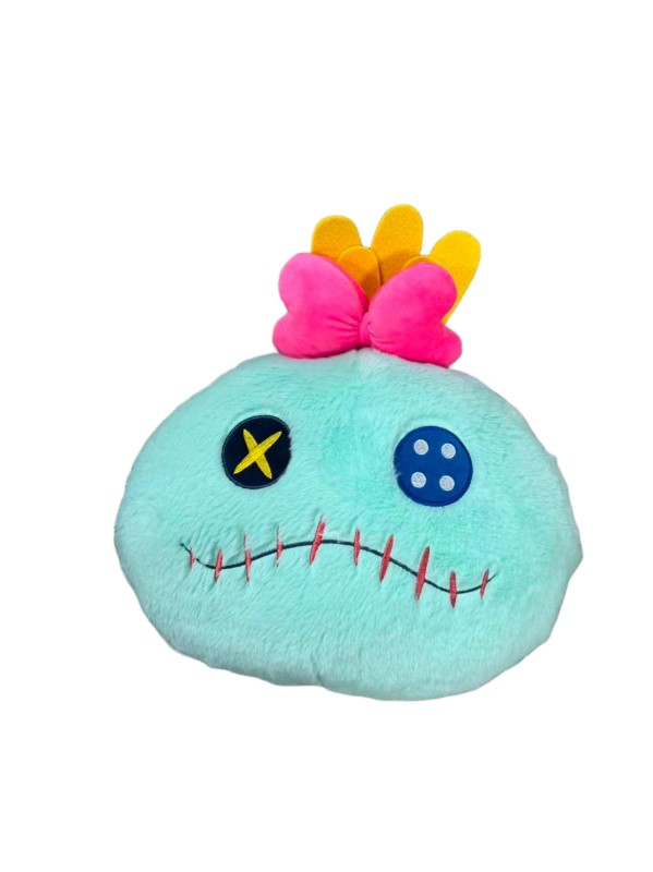 Scrump face cushion — Turquoise face, button-style eye motifs, pink bow and yellow tufts.